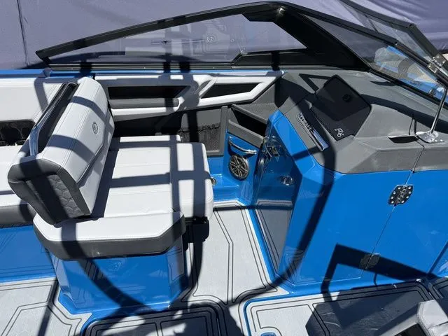 Slide: The Image of 2026 Cobalt R6 Surf boat interior with blue and white seating. - 25