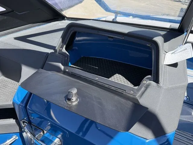 Slide: The Image of Interior view of 2026 Cobalt R6 Surf boat, open storage compartment. - 28
