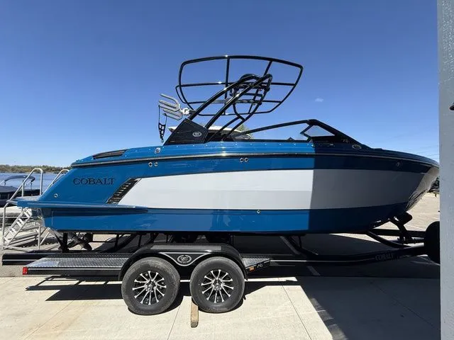 Slide: The Image of 2026 Cobalt R6 Surf boat on trailer, blue and white design. - 3
