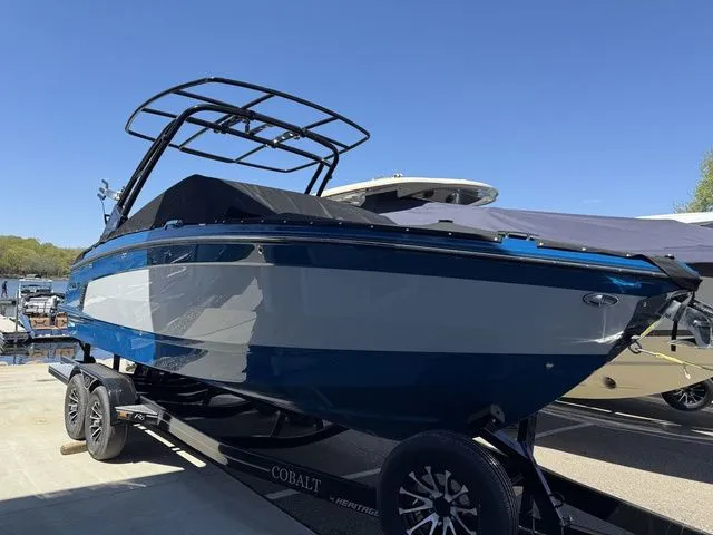 Slide: The Image of 2026 Cobalt R6 Surf boat on trailer outdoors. - 47