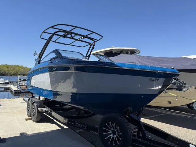 Slide: The Image of 2026 Cobalt R6 Surf boat on trailer at marina. - 2