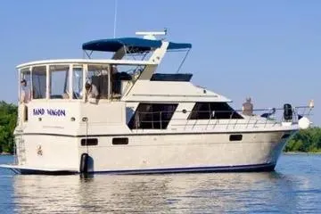 The Image of 1991 Carver 42 Aft Cabin Motor Yacht on calm water, side view. - 0