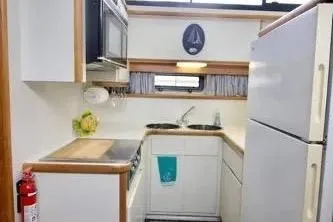Slide: The Image of Interior of 1991 Carver 42 Aft Cabin Motor Yacht with dining area and kitchen. - 11