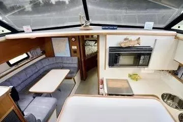 Slide: The Image of 1991 Carver 42 Aft Cabin Motor Yacht interior with cozy bedroom and dining area. - 12