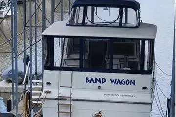 Slide: The Image of 1991 Carver 42 Aft Cabin Motor Yacht docked under a covered marina. - 2