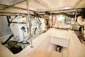 Slide: The Image of Engine room of 1991 Carver 42 Aft Cabin Motor Yacht, showcasing mechanical components. - 23