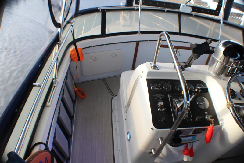 Slide: The Image of 1991 Carver 42 Aft Cabin Motor Yacht helm with controls and navigation equipment. - 26