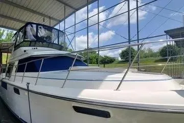 Slide: The Image of 1991 Carver 42 Aft Cabin Motor Yacht docked under a covered structure. - 3