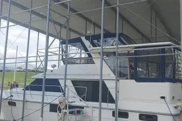 Slide: The Image of 1991 Carver 42 Aft Cabin Motor Yacht docked under a covered marina. - 4