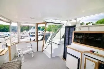 Slide: The Image of 1991 Carver 42 Aft Cabin Motor Yacht interior with seating and outdoor views. - 8