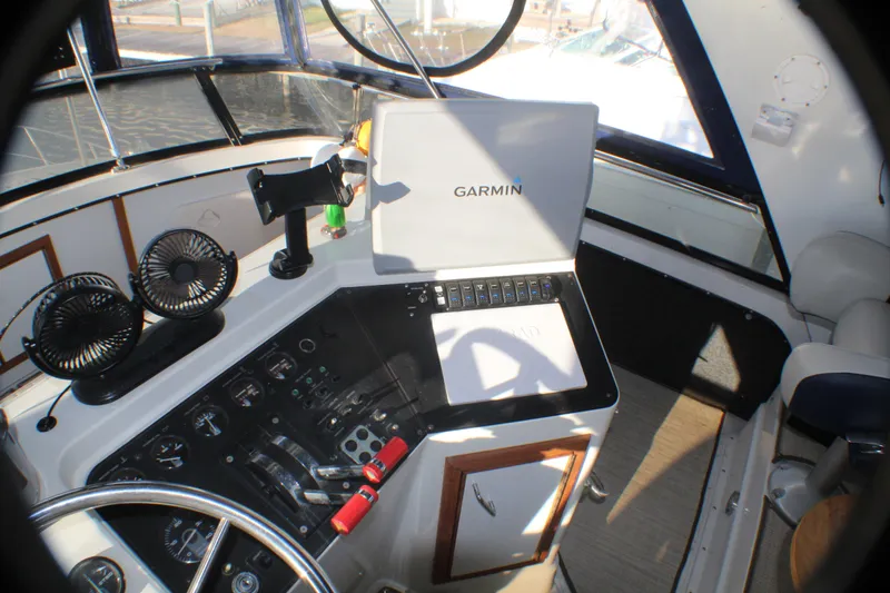 Slide: The Image of 1991 Carver 42 Aft Cabin Motor Yacht helm with Garmin navigation system and dual fans. - 28