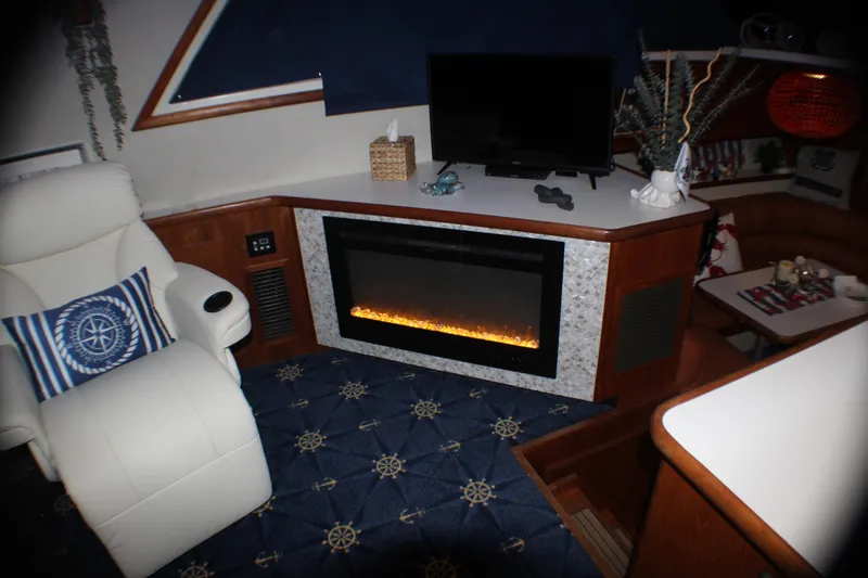Slide: The Image of Luxurious interior of 1991 Carver 42 Aft Cabin Motor Yacht with fireplace and seating. - 34