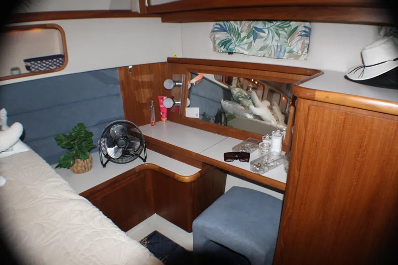 Slide: The Image of Cozy cabin interior of 1991 Carver 42 Aft Cabin Motor Yacht with vanity and decor. - 42