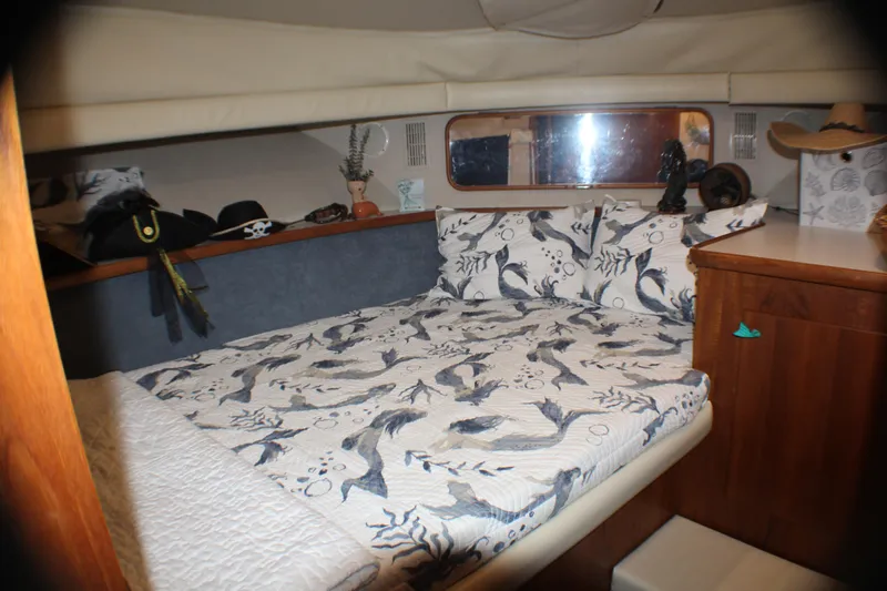Slide: The Image of Cozy bedroom in 1991 Carver 42 Aft Cabin Motor Yacht with nautical-themed bedding. - 48