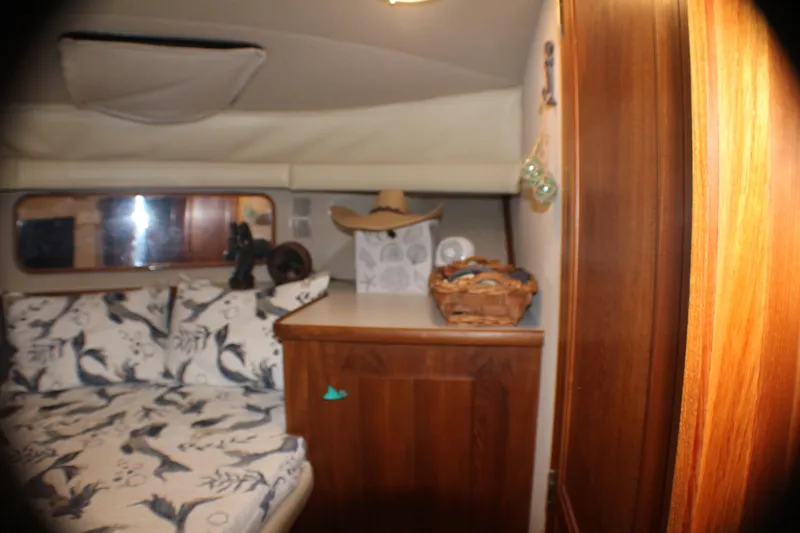 Slide: The Image of Interior of 1991 Carver 42 Aft Cabin Motor Yacht with cozy bed and wooden cabinetry. - 49