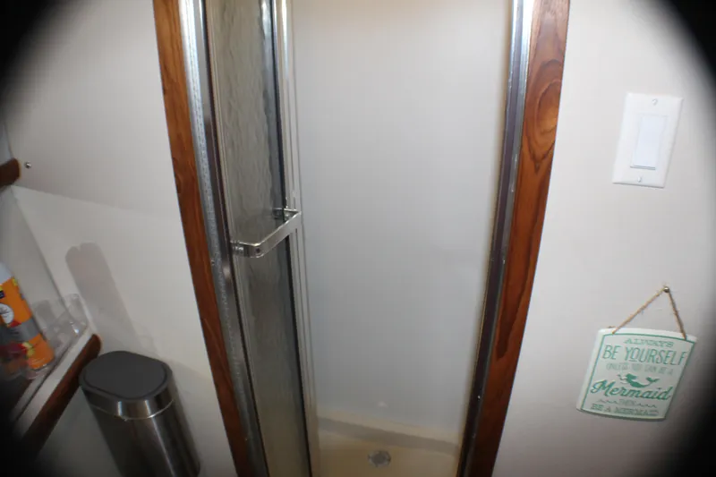 Slide: The Image of Shower area in 1991 Carver 42 Aft Cabin Motor Yacht with wooden trim and decorative sign. - 52
