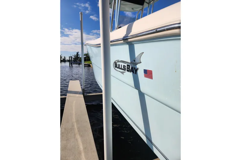 Slide: The Image of 2023 Bulls Bay 230 Center Console boat docked by the water. - 11
