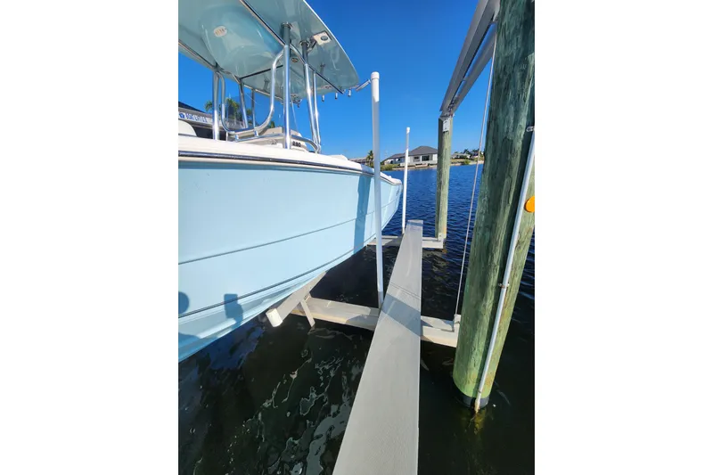 Slide: The Image of 2023 Bulls Bay 230 Center Console boat docked on a sunny day. - 12