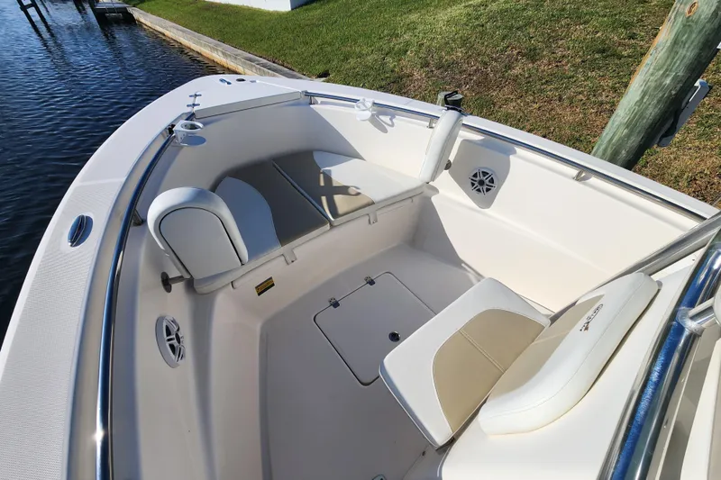 Slide: The Image of 2023 Bulls Bay 230 Center Console boat interior with cushioned seating and speakers. - 5