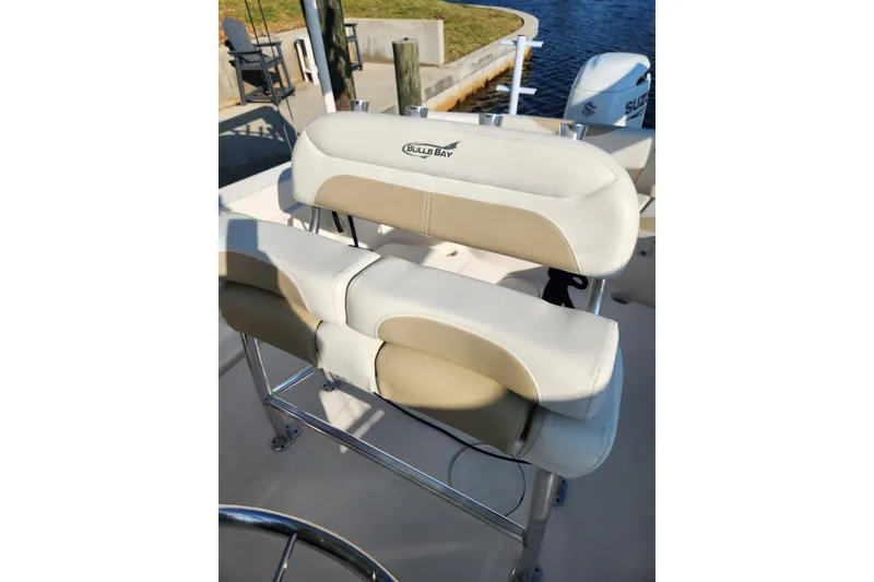 Slide: The Image of 2023 Bulls Bay 230 Center Console boat seating with beige and white upholstery. - 8