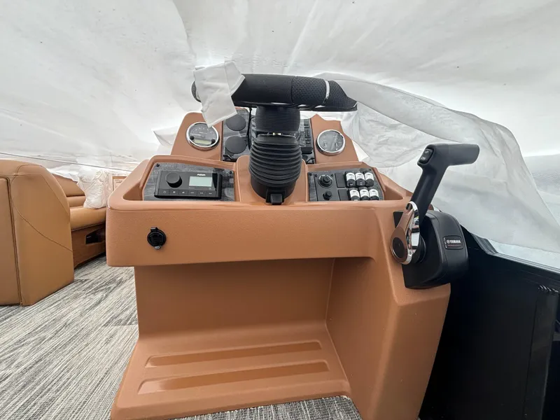 Slide: The Image of Control console of 2025 Avalon Venture Cruise Rear Bench boat, featuring modern navigation equipment. - 2