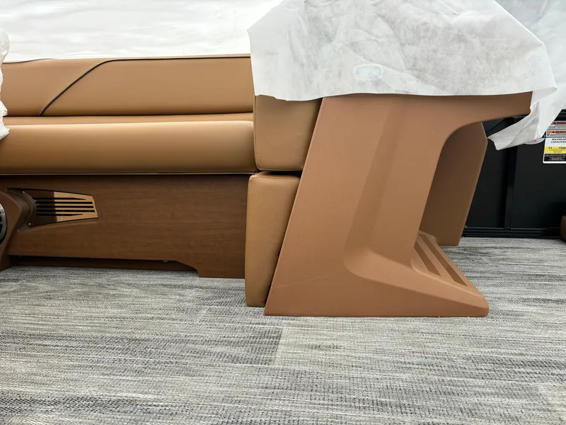 Slide: The Image of 2025 Avalon Venture Cruise Rear Bench with tan upholstery on a carpeted floor. - 4