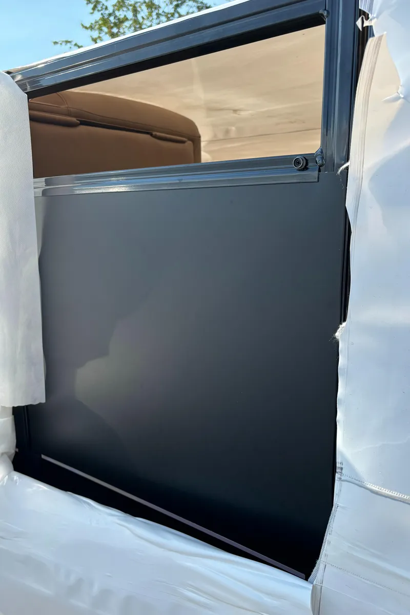 Slide: The Image of 2025 Avalon Venture Cruise Rear Bench, partially covered, showcasing sleek design details. - 9