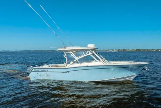 The Image of 2017 Grady-White Freedom 307 boat cruising on open water under clear blue skies. - 0