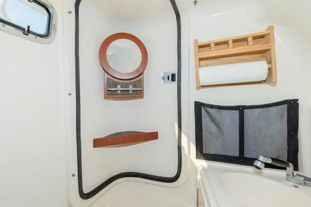 Slide: The Image of 2017 Grady-White Freedom 307 boat interior with mirror, storage, and sink. - 11