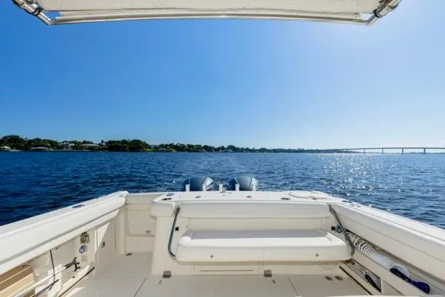 Slide: The Image of 2017 Grady-White Freedom 307 boat on open water under clear blue sky. - 13