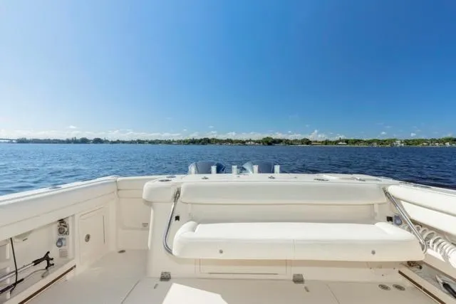 Slide: The Image of 2017 Grady-White Freedom 307 boat on calm water under clear blue sky. - 14