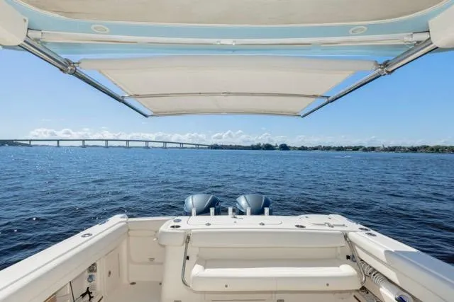 Slide: The Image of 2017 Grady-White Freedom 307 boat with dual engines, open water view, and bridge in the distance. - 16