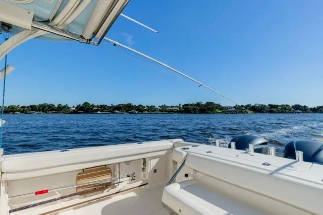 Slide: The Image of 2017 Grady-White Freedom 307 boat on open water under clear blue sky. - 17