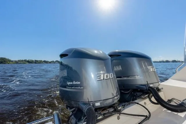 Slide: The Image of Twin Yamaha 300 engines on a 2017 Grady-White Freedom 307 boat, cruising on a sunny day. - 20