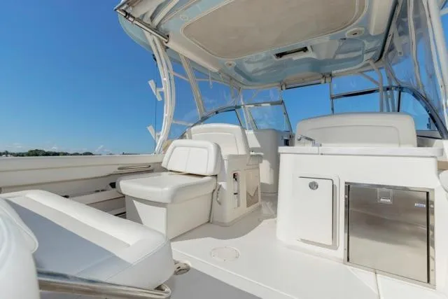 Slide: The Image of 2017 Grady-White Freedom 307 boat interior with seating and storage under clear blue sky. - 21
