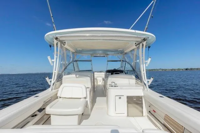 Slide: The Image of 2017 Grady-White Freedom 307 boat on open water, showcasing spacious seating and helm. - 22