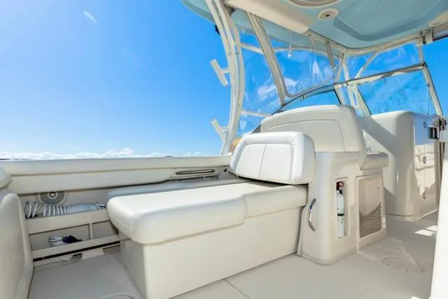 Slide: The Image of 2017 Grady-White Freedom 307 boat interior with white seating and clear blue sky. - 23