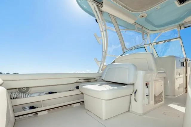 Slide: The Image of 2017 Grady-White Freedom 307 boat interior with seating and clear blue sky. - 24