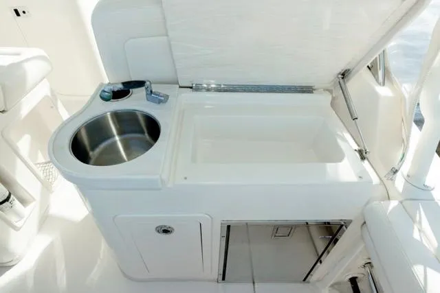Slide: The Image of 2017 Grady-White Freedom 307 boat interior with sink and storage area. - 26