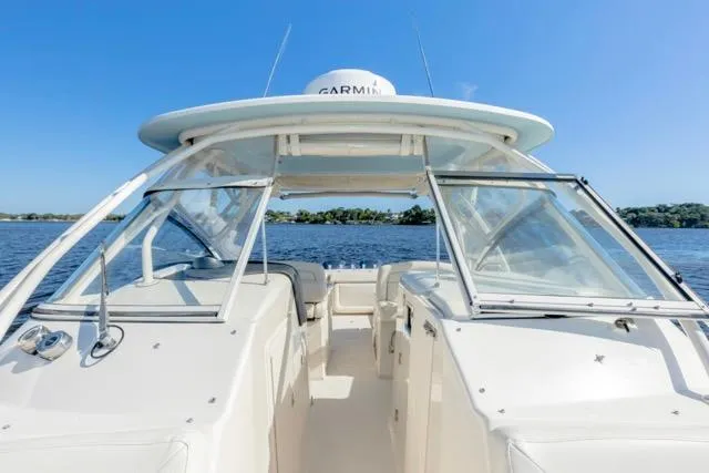 Slide: The Image of 2017 Grady-White Freedom 307 boat on calm water under clear blue sky. - 3