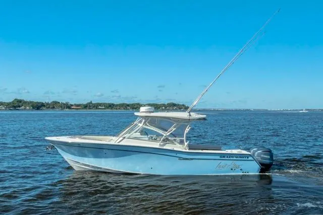 Slide: The Image of 2017 Grady-White Freedom 307 boat cruising on open water under clear blue skies. - 30
