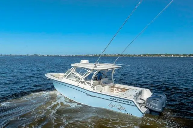 Slide: The Image of 2017 Grady-White Freedom 307 boat cruising on open water under clear blue skies. - 31