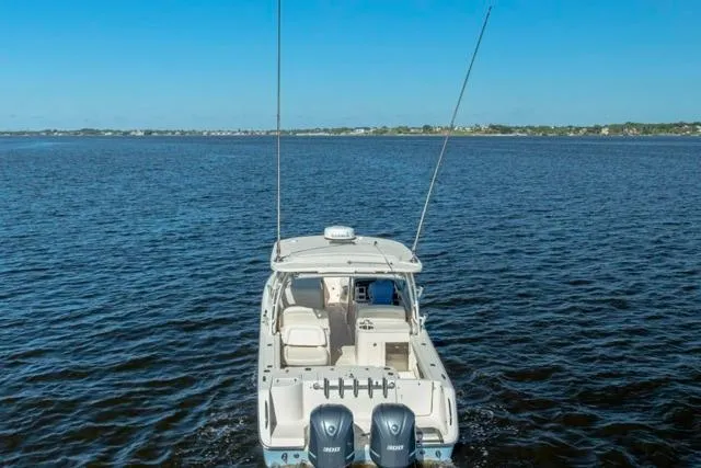 Slide: The Image of 2017 Grady-White Freedom 307 boat on open water, rear view with dual engines. - 32