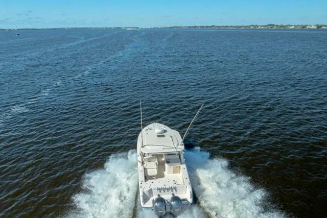Slide: The Image of 2017 Grady-White Freedom 307 boat cruising on open water, aerial view. - 42