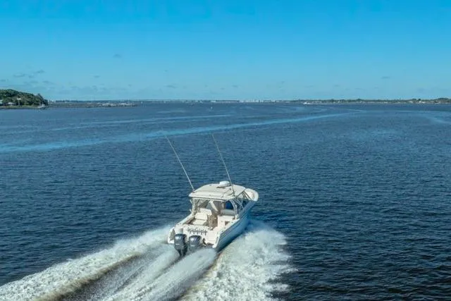 Slide: The Image of 2017 Grady-White Freedom 307 cruising on open water under clear blue skies. - 45