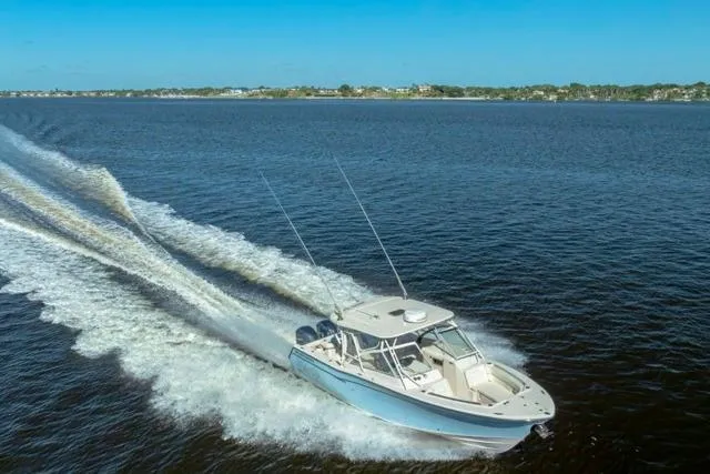 Slide: The Image of 2017 Grady-White Freedom 307 boat cruising on open water under clear blue skies. - 50