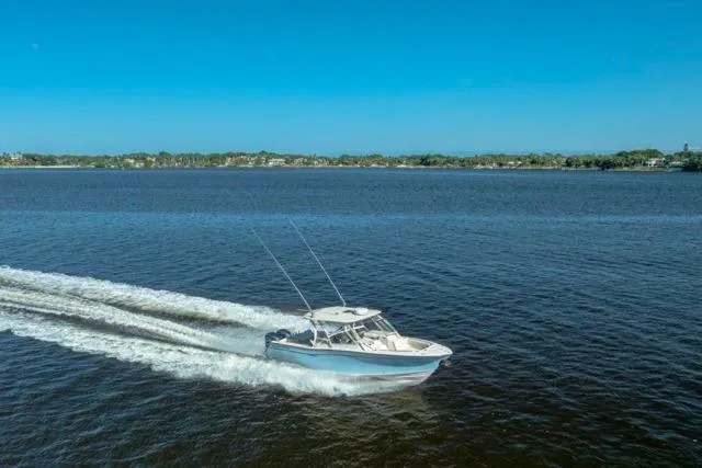 Slide: The Image of 2017 Grady-White Freedom 307 boat cruising on a calm blue lake. - 51
