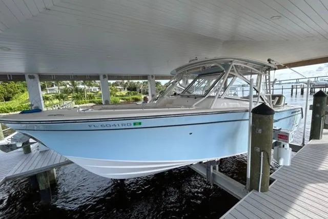 Slide: The Image of 2017 Grady-White Freedom 307 boat docked under covered marina. - 53