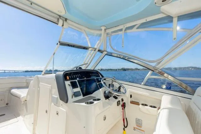 Slide: The Image of 2017 Grady-White Freedom 307 boat interior with steering wheel and navigation system. - 6