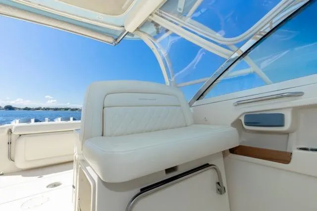 Slide: The Image of 2017 Grady-White Freedom 307 boat interior with white seating and ocean view. - 8